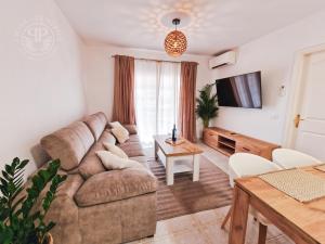 a living room with a couch and a table at 2 Wings Tenerife - Apartment Chayofa in Chayofa