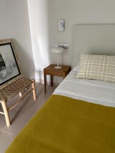 a bedroom with a bed and a table with a lamp at OMBÚLAFUENTE in Puerto de Mogán