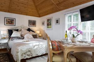 a bedroom with a bed and a table and a table and a tableablish at Alpaca Lodge in Burford