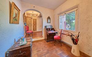 a room with a desk and chairs and a window at VILLA MERCEDES 300 m de la plage in La Londe-les-Maures