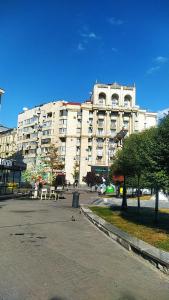 a large white building with tables and chairs in front of it at Апартаменты в самом центре столицы. in Kyiv