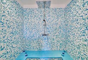 a bathroom with a bath tub with a shower at VILLA MERCEDES 300 m de la plage in La Londe-les-Maures +37 photos