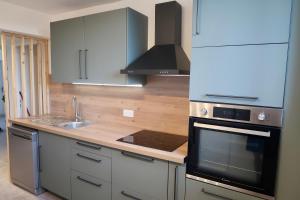 a kitchen with a stove top oven next to a sink at Appartement cosy à Perpignan ! in Perpignan