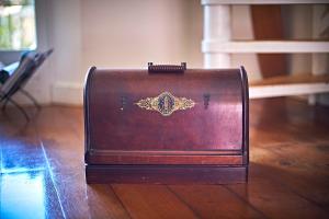 a brown briefcase sitting on a wooden floor at VILLA MERCEDES 300 m de la plage in La Londe-les-Maures