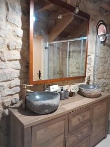 a bathroom with two sinks on a counter with a mirror at Loft Estación Quintana in Gijón