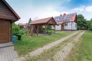 a house with a roof with solar panels on it at Happy Bison - A 5 Bedroom House With A Garden in Białowieża