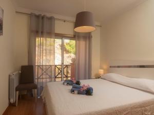 a bedroom with a bed with stuffed animals on it at Holiday Home O segredo de Sesimbra by Interhome in Sesimbra