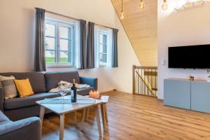 a living room with a couch and a table at Landluft Ferien - Wohnung Abendrot in Heiligenberg