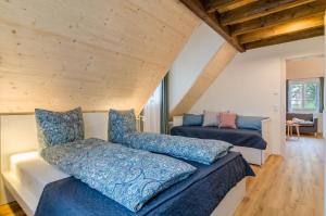 Cette chambre comprend deux lits et un canapé. dans l'établissement Landluft Ferien - Wohnung Abendrot, à Heiligenberg