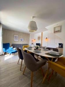 a dining room and living room with a table and chairs at Chalet de 3 chambres a Le Devoluy a 200 m des pistes avec piscine partagee sauna et terrasse in Le Dévoluy