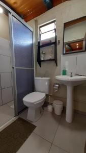 a bathroom with a toilet and a sink at Cabana Casa Enxaimel in Picada Cafe