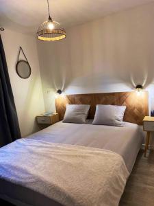 a bedroom with a large white bed with two pillows at Chalet de 3 chambres a Le Devoluy a 200 m des pistes avec piscine partagee sauna et terrasse in Le Dévoluy