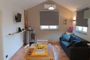 a living room with a blue couch and a table at La Tana del Berü in Varazze +8 photos
