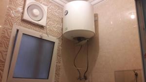 a light on the wall of a bathroom with a mirror at كوتاج المفروشة in Al Khobar