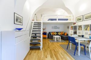 a room with a loft bed and a living room with a table at Main Square Studio Mare in Zagreb