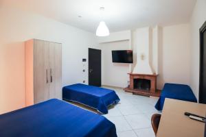 a room with two beds and a tv and a fireplace at max hotel e restaurant in Pontecagnano