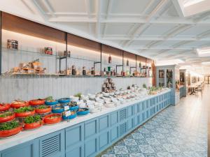 a buffet line with bowls of food on display at Kremlin Palace in Lara