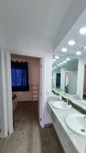 a bathroom with two sinks and a large mirror at Sands Beach - Hoy Hotels in Costa Teguise