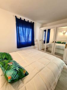 a bedroom with a large bed with a blue curtain at Sands Beach - Hoy Hotels in Costa Teguise
