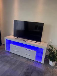 a white entertainment center with a flat screen tv on it at BK Apartments in Lörrach