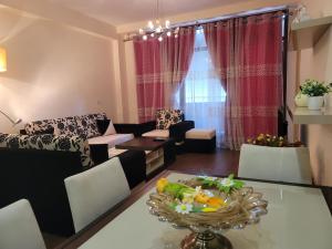 ein Wohnzimmer mit einem Sofa und einem Tisch in der Unterkunft Spacious and Cozy Apartment in Tirana