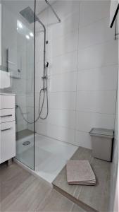 a bathroom with a glass shower with a toilet at Seeblick in Daisendorf