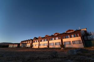 a large building in the middle of a field at Rochester Calafate in El Calafate