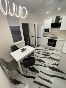 a kitchen with a table and chairs in a room at VIP new apartment Odessa in Odesa