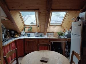 a small kitchen with a table and a refrigerator at Landrosace in Le Monêtier-les-Bains