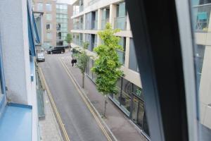 a tree on the side of a building next to a street at 2 Bedroom Central London Apartment Modern and Stylish in London