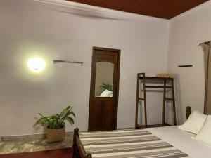 a bedroom with a bed with a mirror and a ladder at The Clift in Varkala