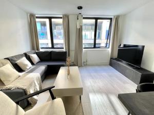 a living room with a couch and a table at 2 Bedroom Central London Apartment Modern and Stylish in London