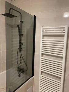 a shower with a glass door in a bathroom at 2 Bedroom Central London Apartment Modern and Stylish in London