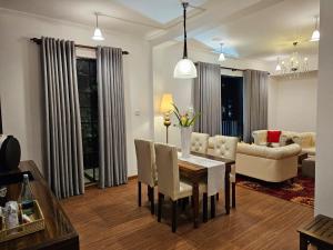 a living room with a table and chairs and a couch at Covanro Sigiriya - Where Heritage Meets Luxury in Sigiriya