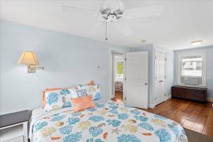 a bedroom with a bed and a ceiling fan at Glades Manor: Minot Beach Scituate in Scituate