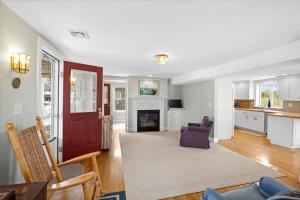 a living room with a couch and a fireplace at Glades Manor: Minot Beach Scituate in Scituate
