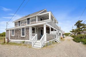 an older house with a porch and white stairs at Glades Manor: Minot Beach Scituate in Scituate