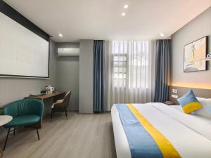 a hotel room with a bed and a desk at Xian Feng Hotel - Tianfu International Airport Branch in Jianyang