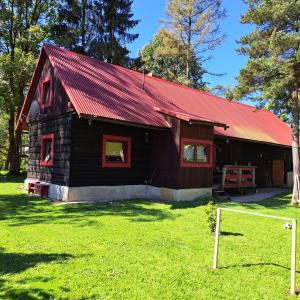 a red and black barn with a red roof at Drevenica Emma in Oravská Polhora