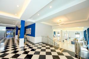 a lobby with a checkered floor and blue walls at Marble Arch De Loei Hotel in Loei