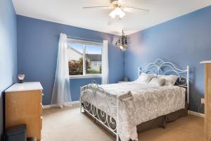 a blue bedroom with a bed and a window at 3BR 2,5BA - Ready to move in - utensils, furniture and appliances in Renton