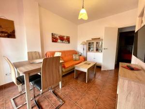 a living room with a bed and a dining room at Apartamento Rocio Al-Andalus in Chiclana de la Frontera