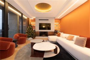 a living room with a white couch and a christmas tree at Les 7 Anges - Cathédrale de Reims in Reims