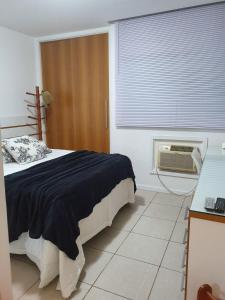 a bedroom with a large bed and a window at Lapinha 40 Graus Studio in Rio de Janeiro