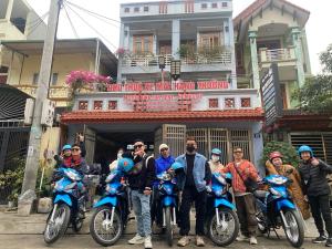 un grupo de personas posando para una foto con sus motocicletas en Hằng Thường Hostel - Motorbikes And Tour, en Ha Giang