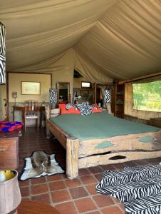 a bedroom with a large bed in a tent at Buffalo's Rest Greenpark-Naivasha in Naivasha