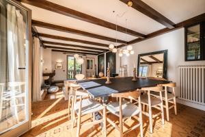 a dining room with a wooden table and chairs at Chalet La Rose de Clairiere Morzine - BY EMERALD STAY in Morzine