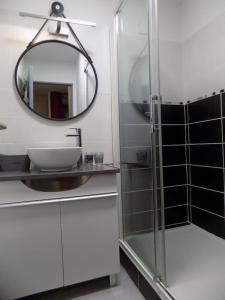 a bathroom with a sink and a mirror at studio nimes costieres loggia parking in Nîmes