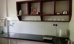 a kitchen with a sink and a counter top at Indeevaram Residency in Trivandrum
