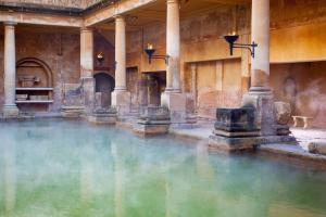 a pool of water in a building with columns at Pure B - Welcoming Bath City 3 Bed House Free Parking & Wifi in Bath